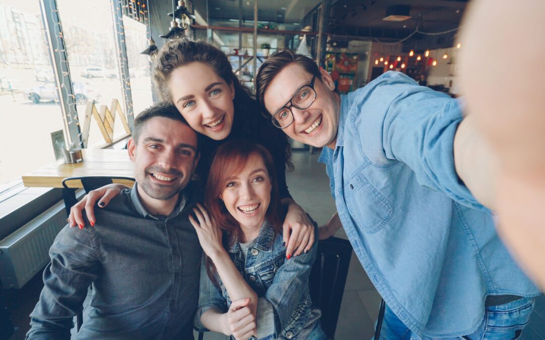 A group of four people taking a selfie together.
