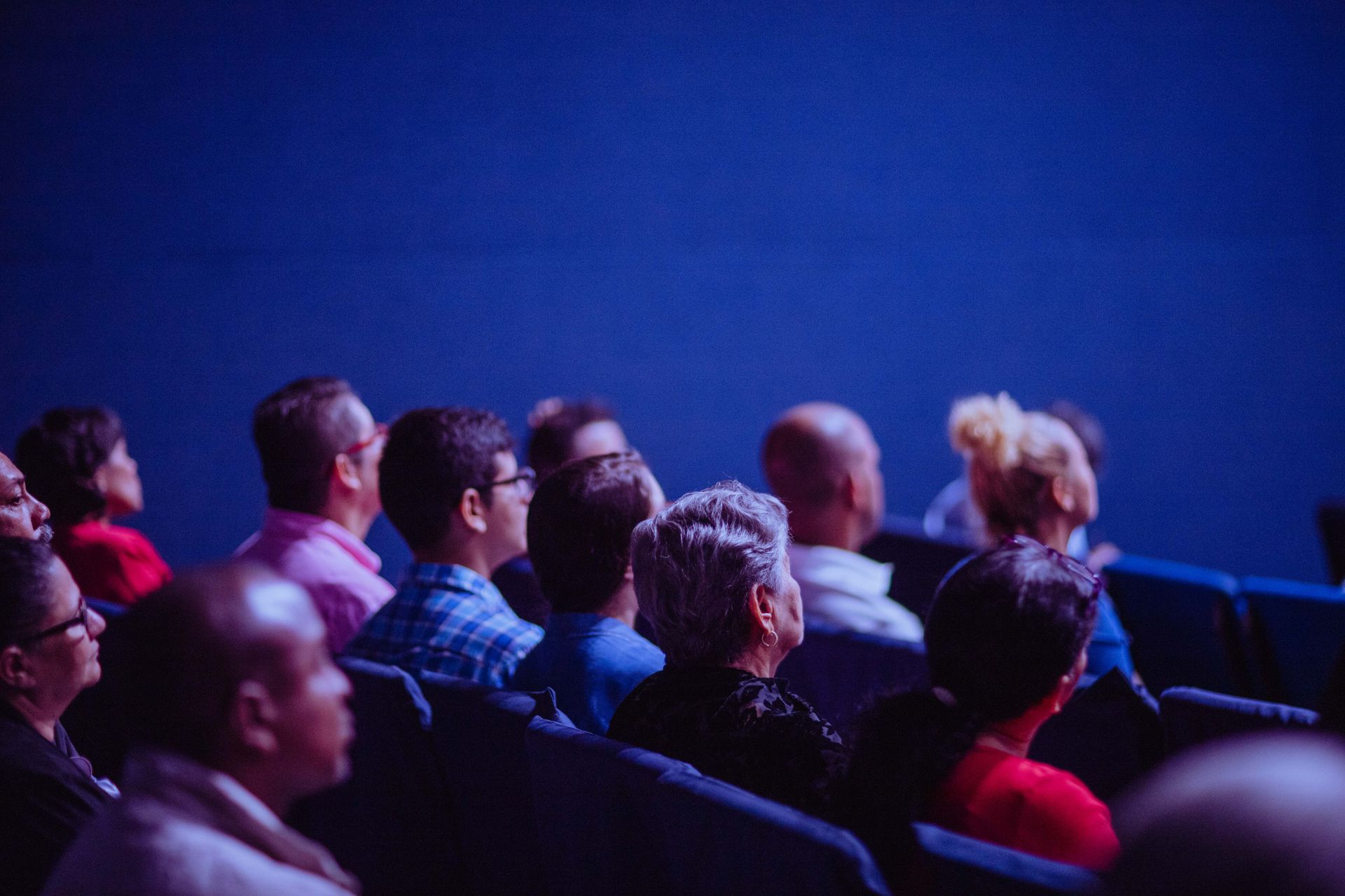 People sitting in rows of seats listening.
